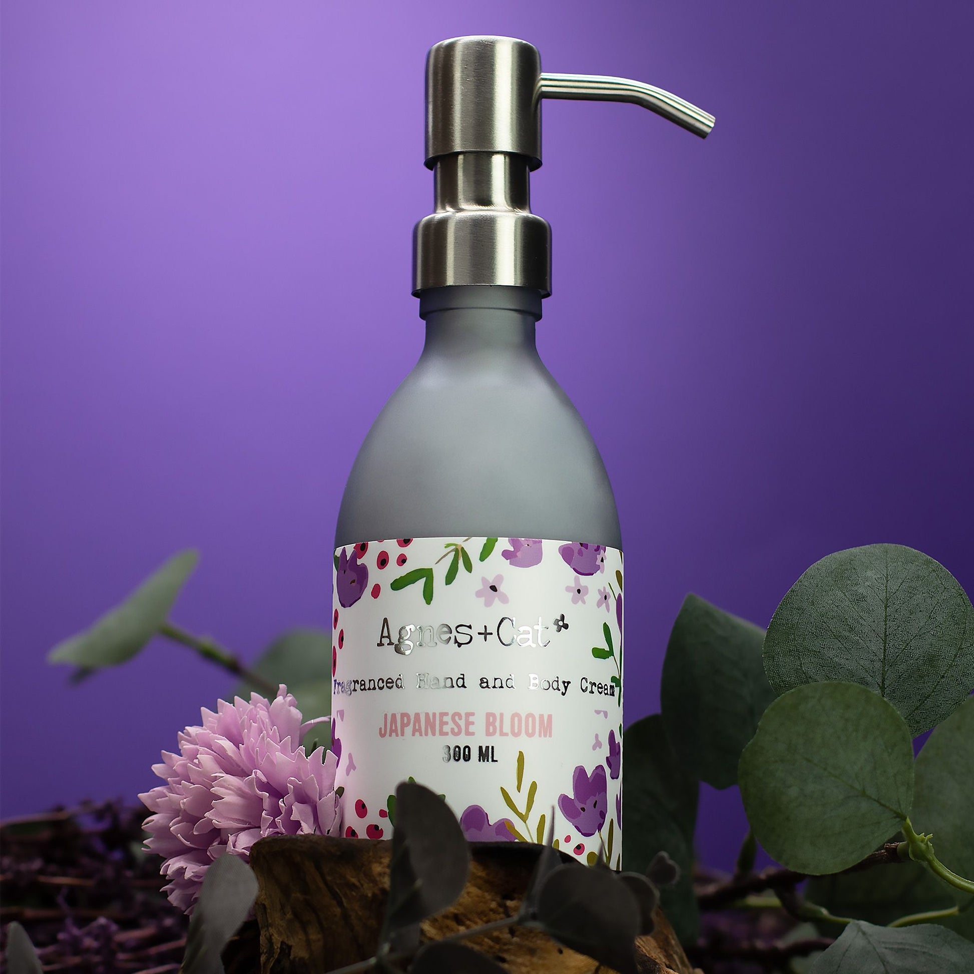 Agnes+Cat Japanese Bloom Hand and Body Cream in a frosted bottle with a silver pump.