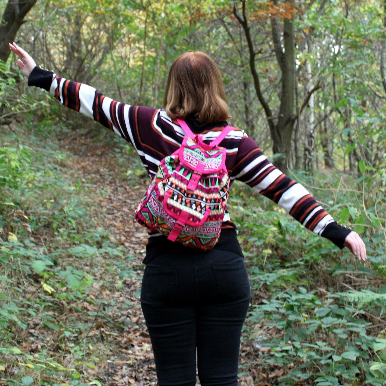 Jacquard backpack with pink straps and a colorful ethnic pattern.