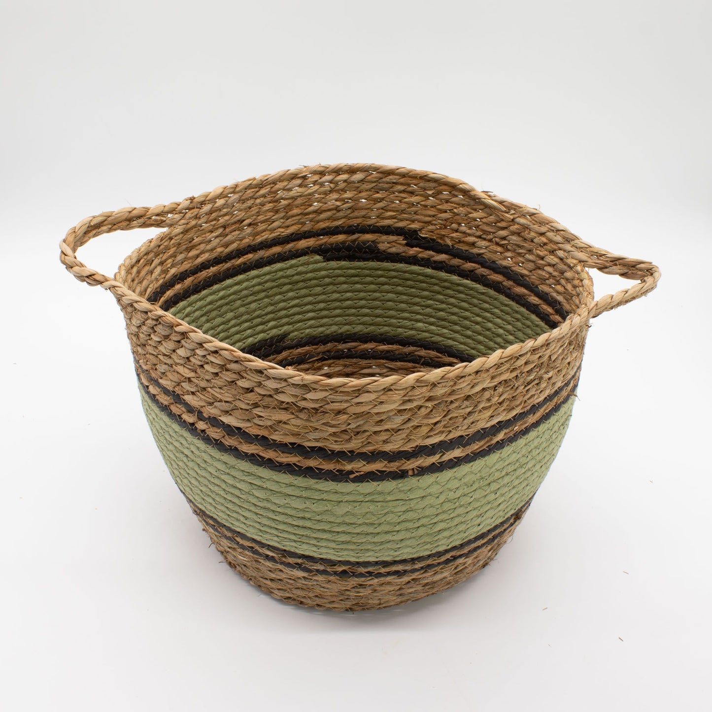Woven seagrass basket with green and black stripes and rope handles.