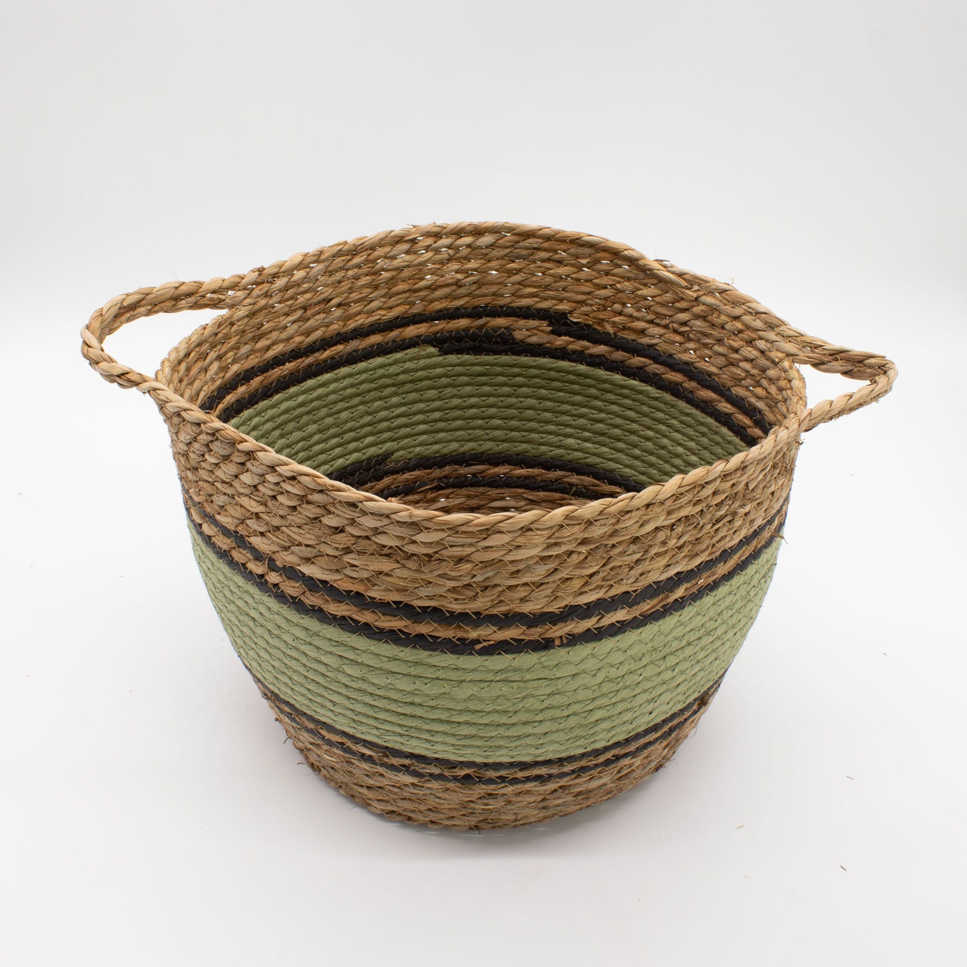 Woven seagrass basket with green and black stripes and rope handles.