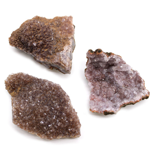 Drei rohe Amethyst-Kristallcluster auf weißem Hintergrund.