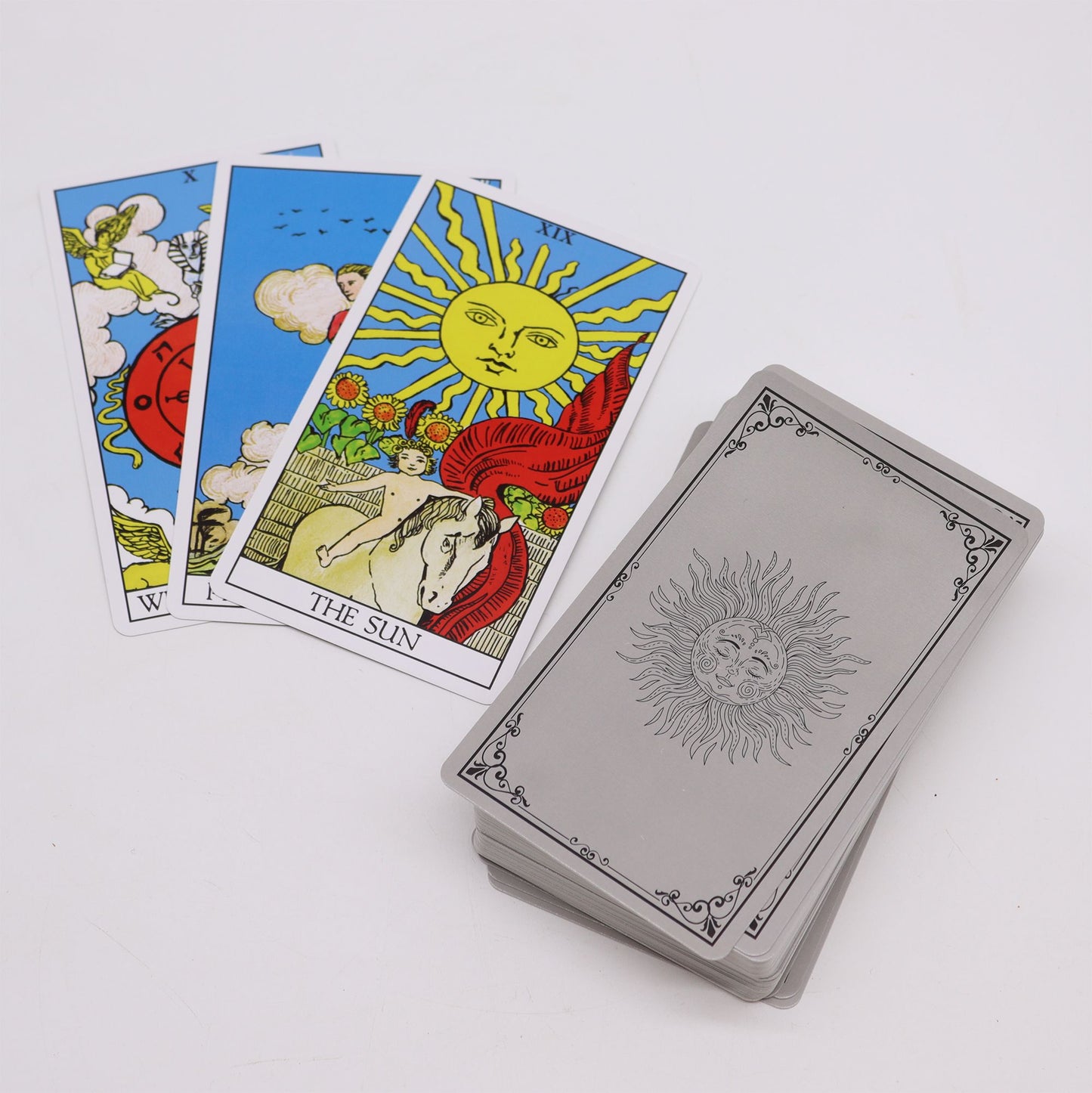 Tarot cards with a sun design on the back and traditional arcana imagery on the front.