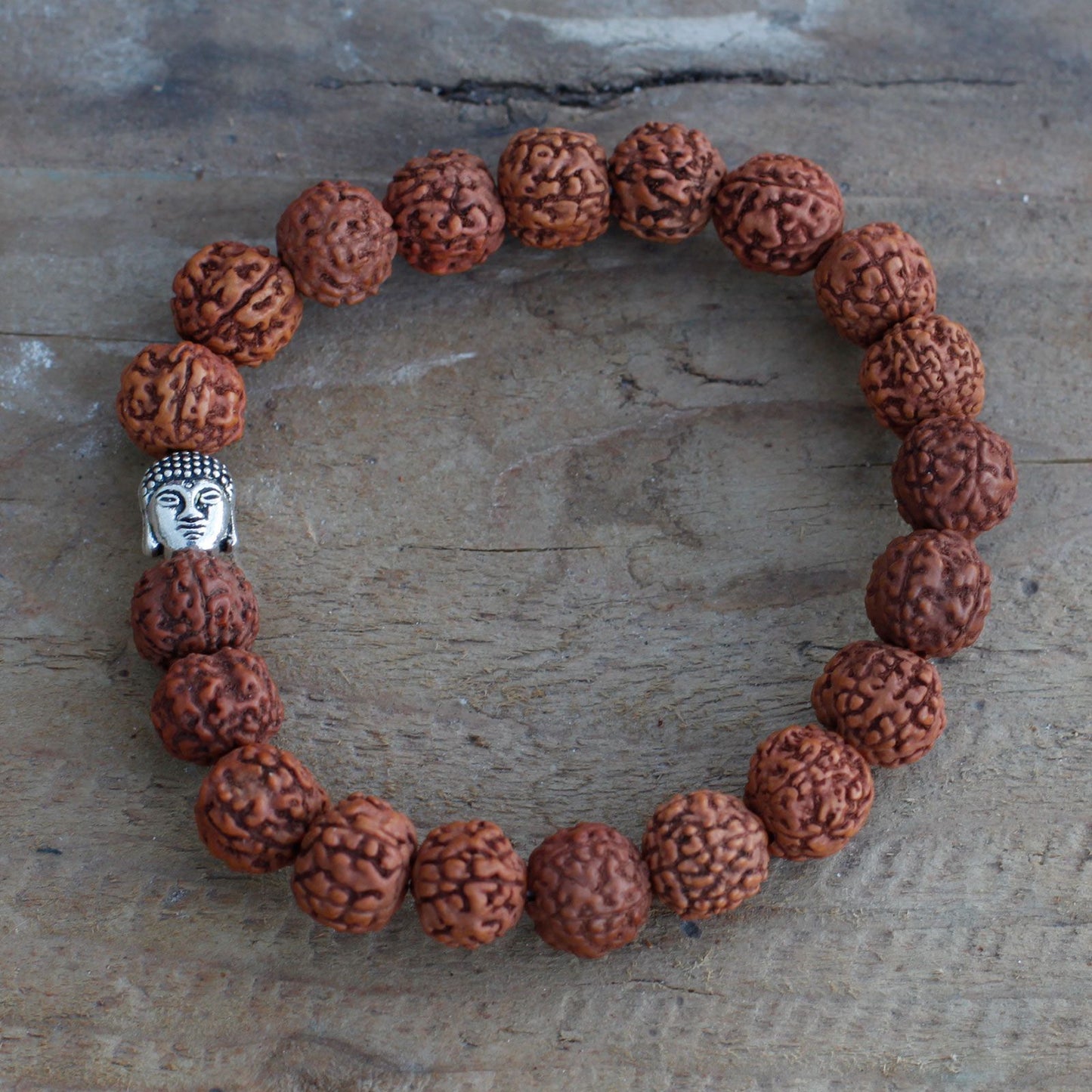 Rudraksha bangle mala with a silver Buddha head charm.