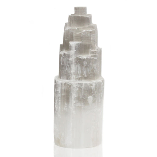 A natural selenite tower lamp with a tiered, skyscraper-like shape.