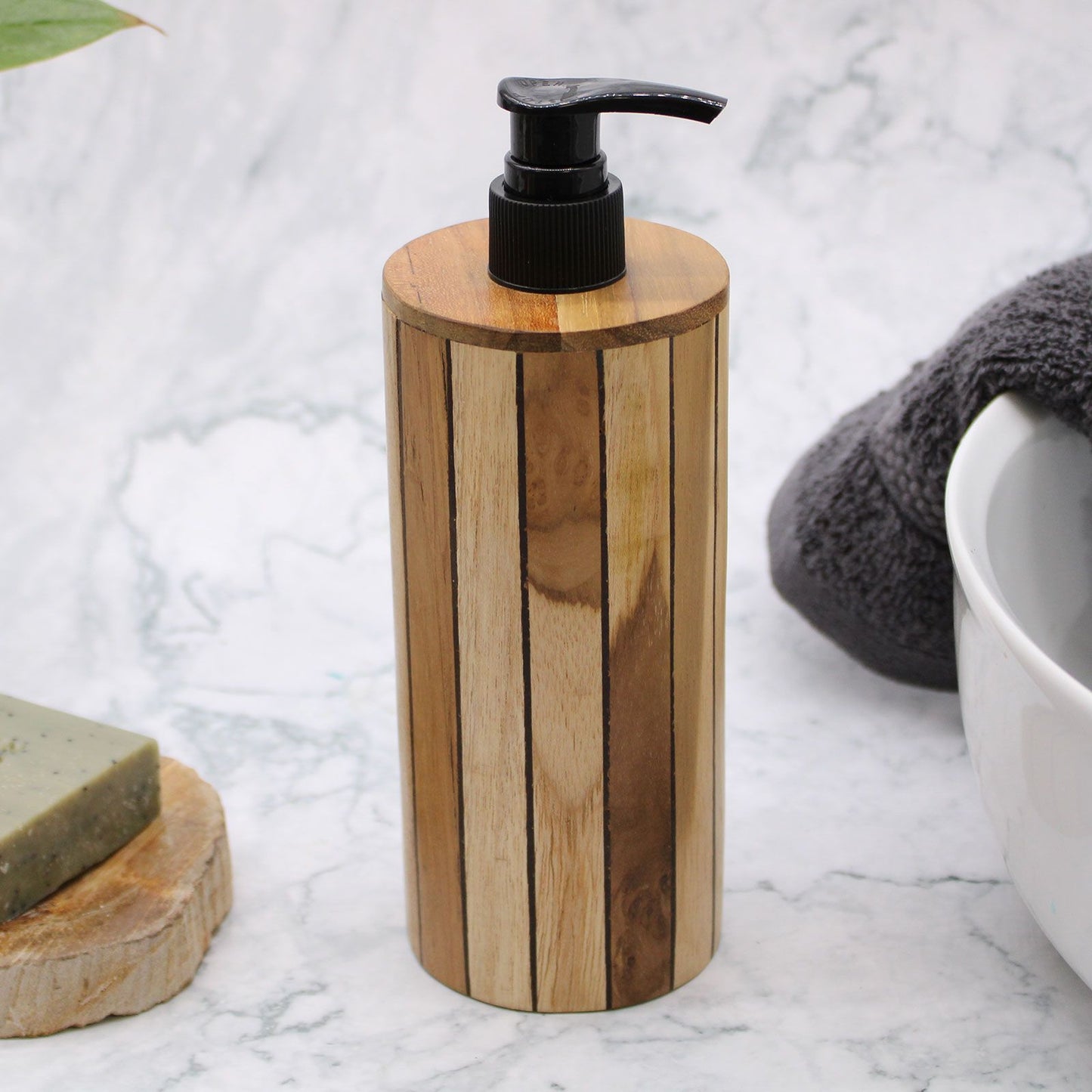 Natural teakwood soap dispenser with a black pump on a marble surface.