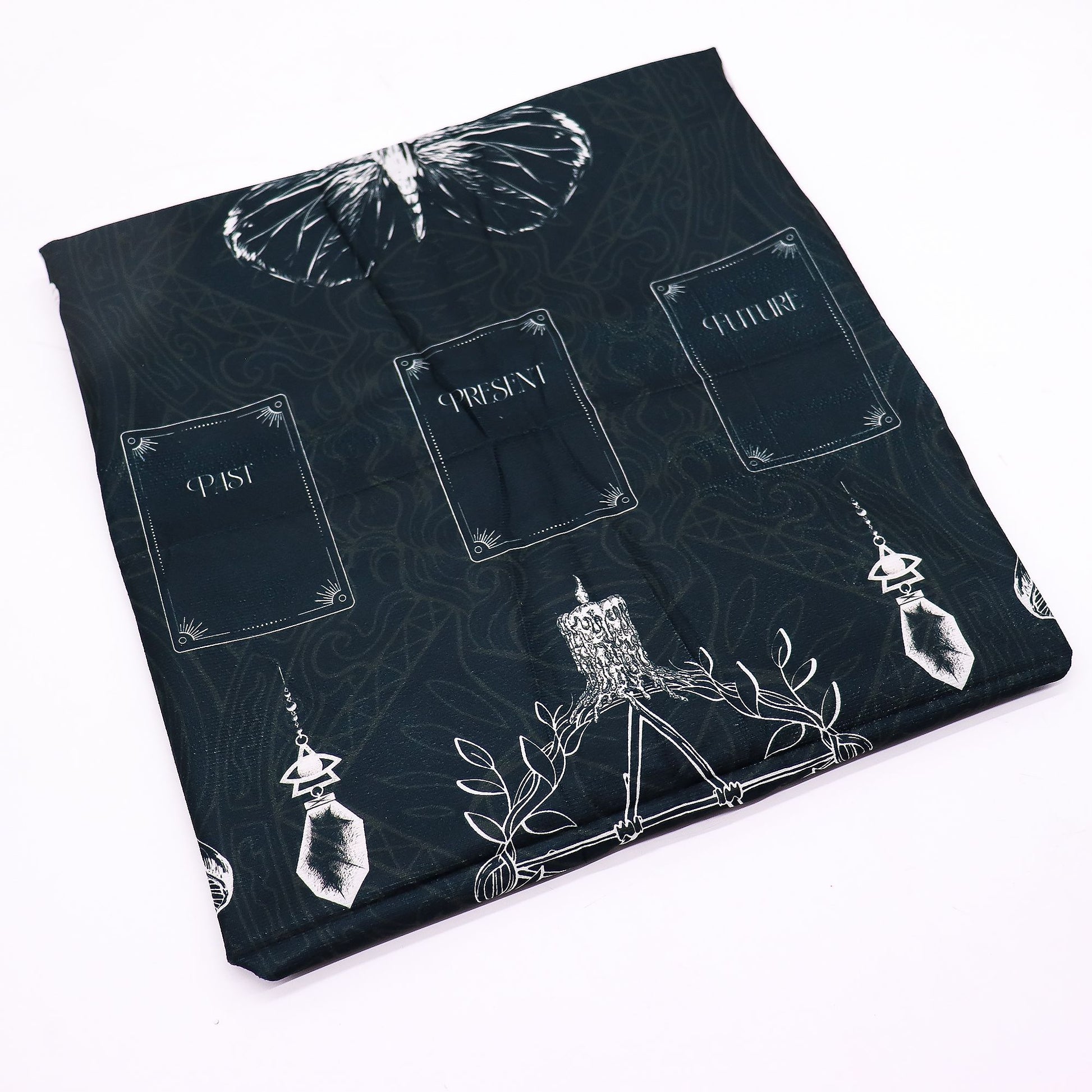 Tarot reading cloth with a butterfly, candle, and crystal design.