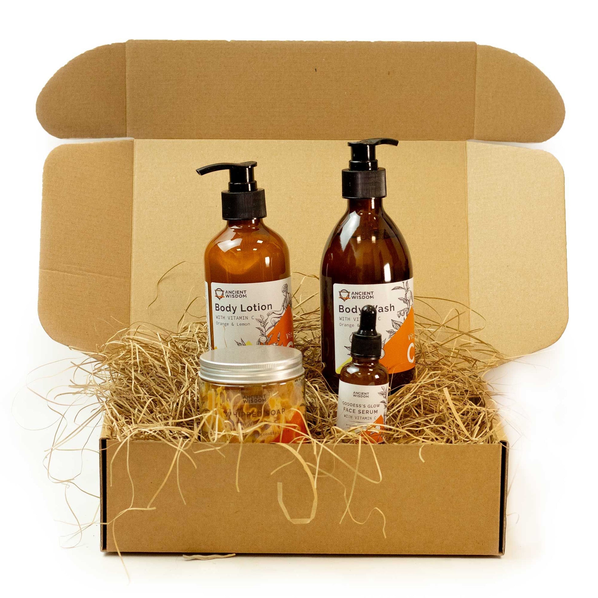 Glow & Refresh Luxe Set featuring body lotion, body wash, face serum, and whipped soap in a gift box.