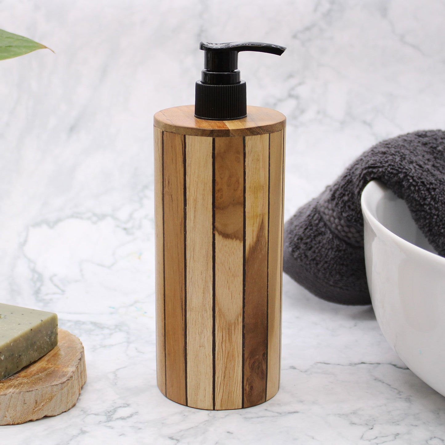 Natural teakwood soap dispenser with a black pump on a marble surface.