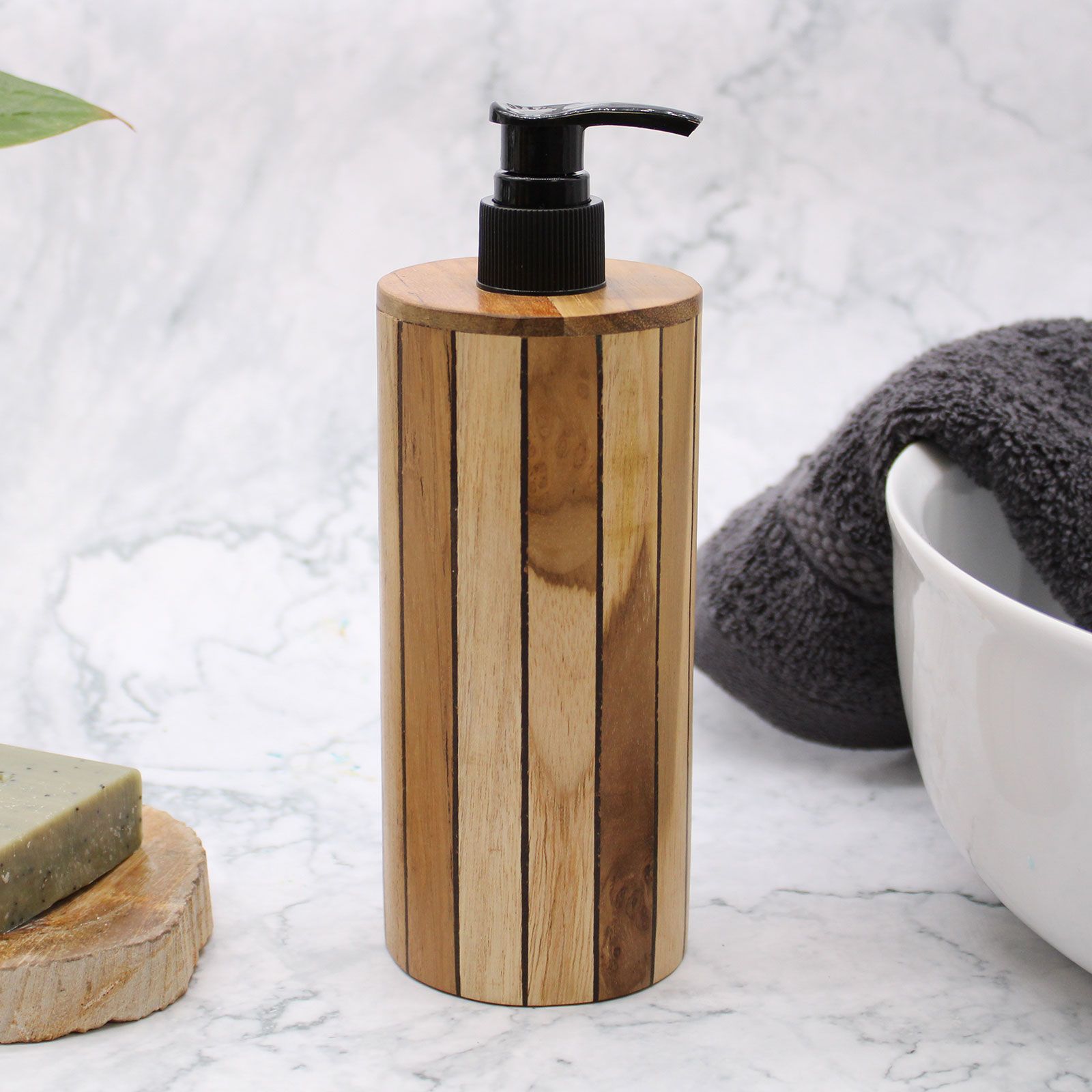 Natural teakwood soap dispenser with a black pump on a marble surface.
