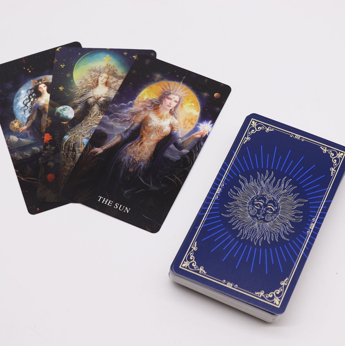 Tarot cards with goddess illustrations and a blue sun-themed guidebook.