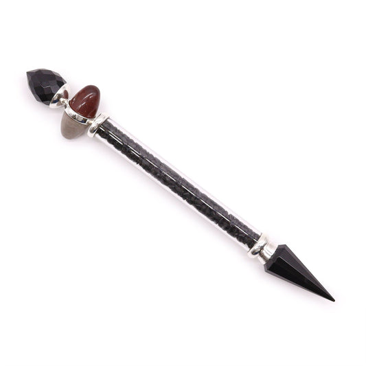 A magic wand with black tourmaline, agate, and a clear tube filled with black stones.
