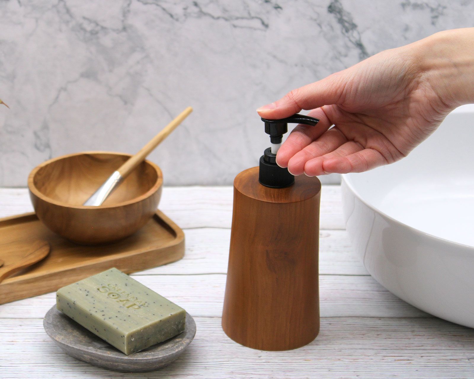 Natural teakwood soap dispenser with a tapered base.