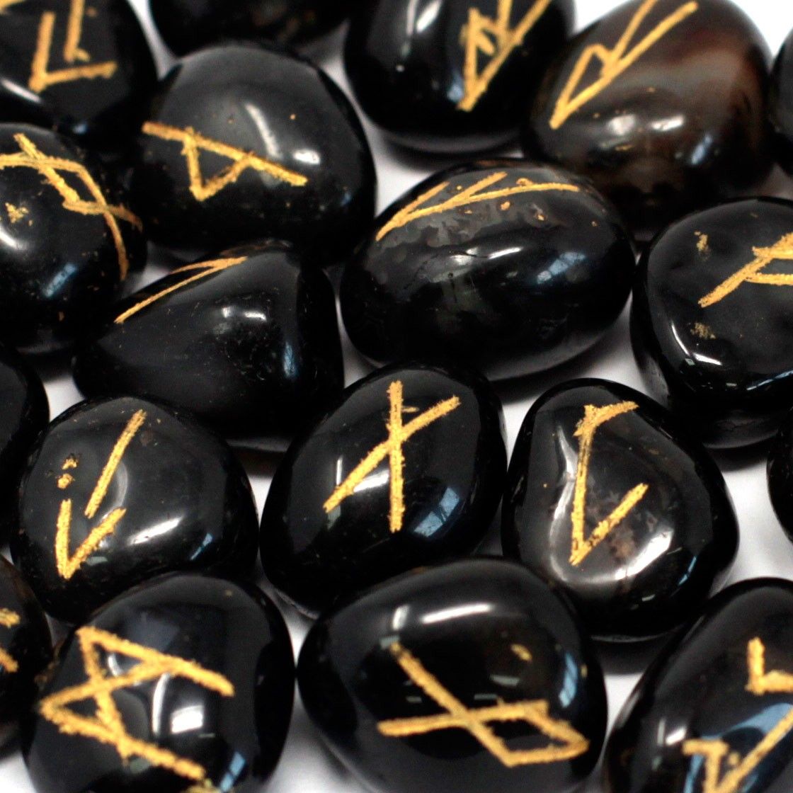 Black onyx rune stones with gold symbols.