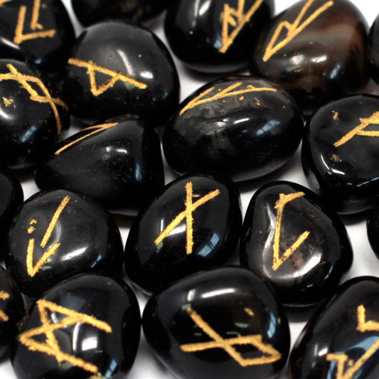 Black onyx rune stones with gold symbols.