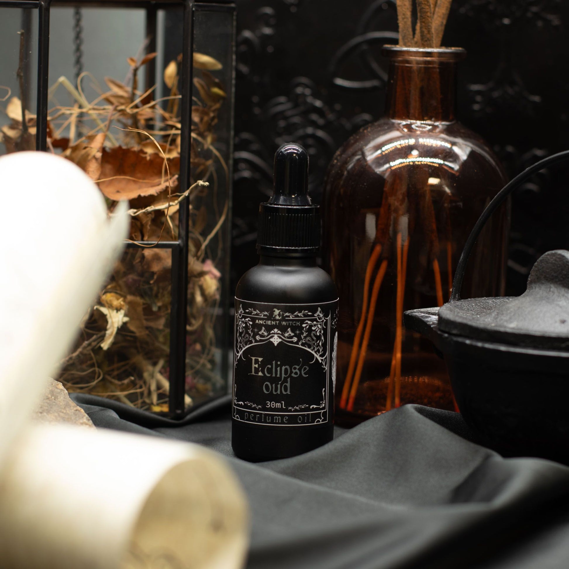 Ancient Witch Eclipse Oud perfume oil in a black bottle.
