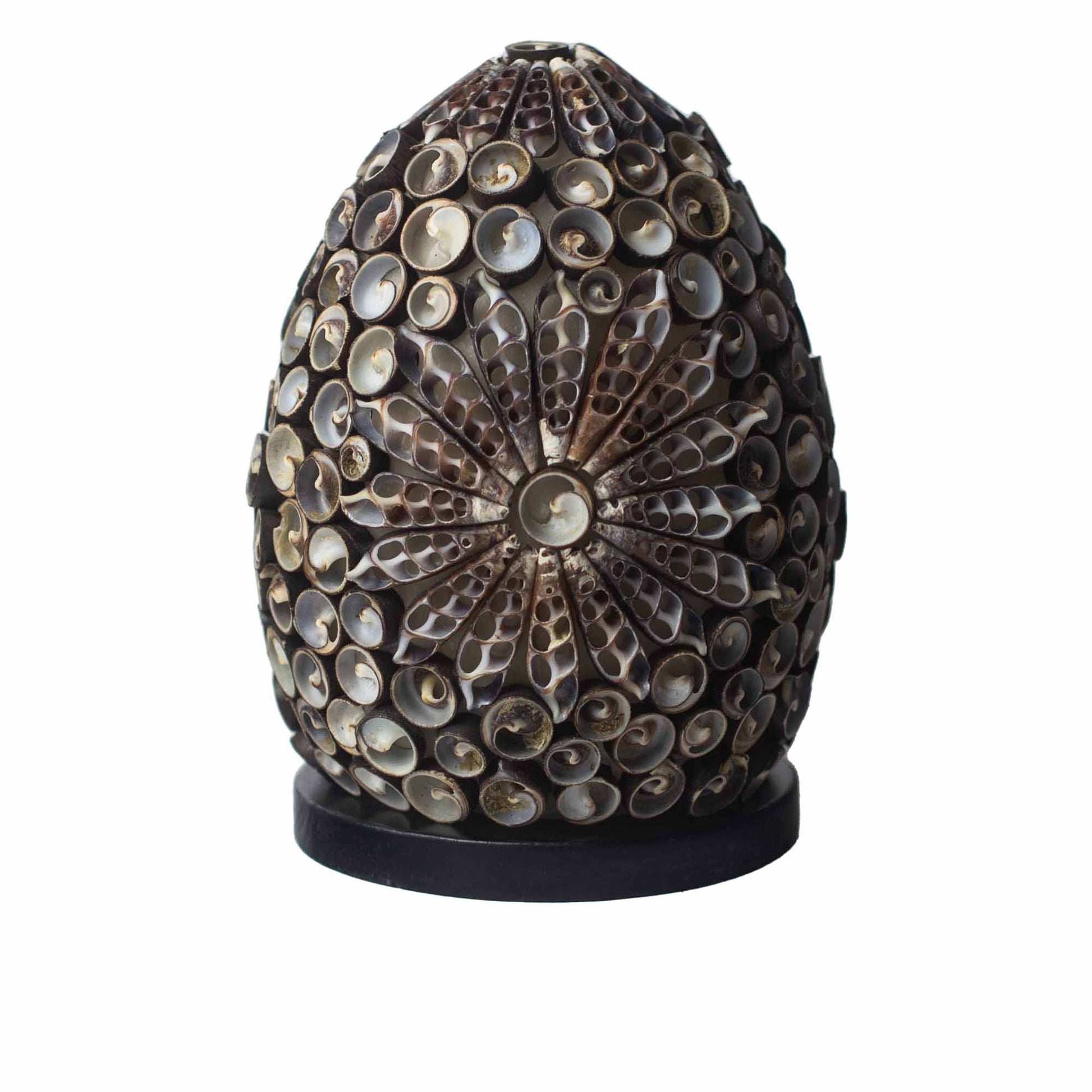 Oval lamp covered in small, curled seashells with a floral pattern.