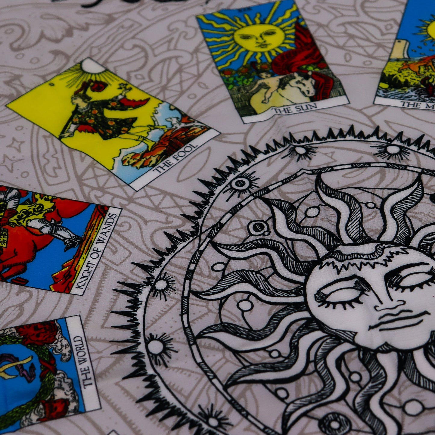 Tarot cloth with Tree of Life design and tarot cards including The Fool and The Sun.