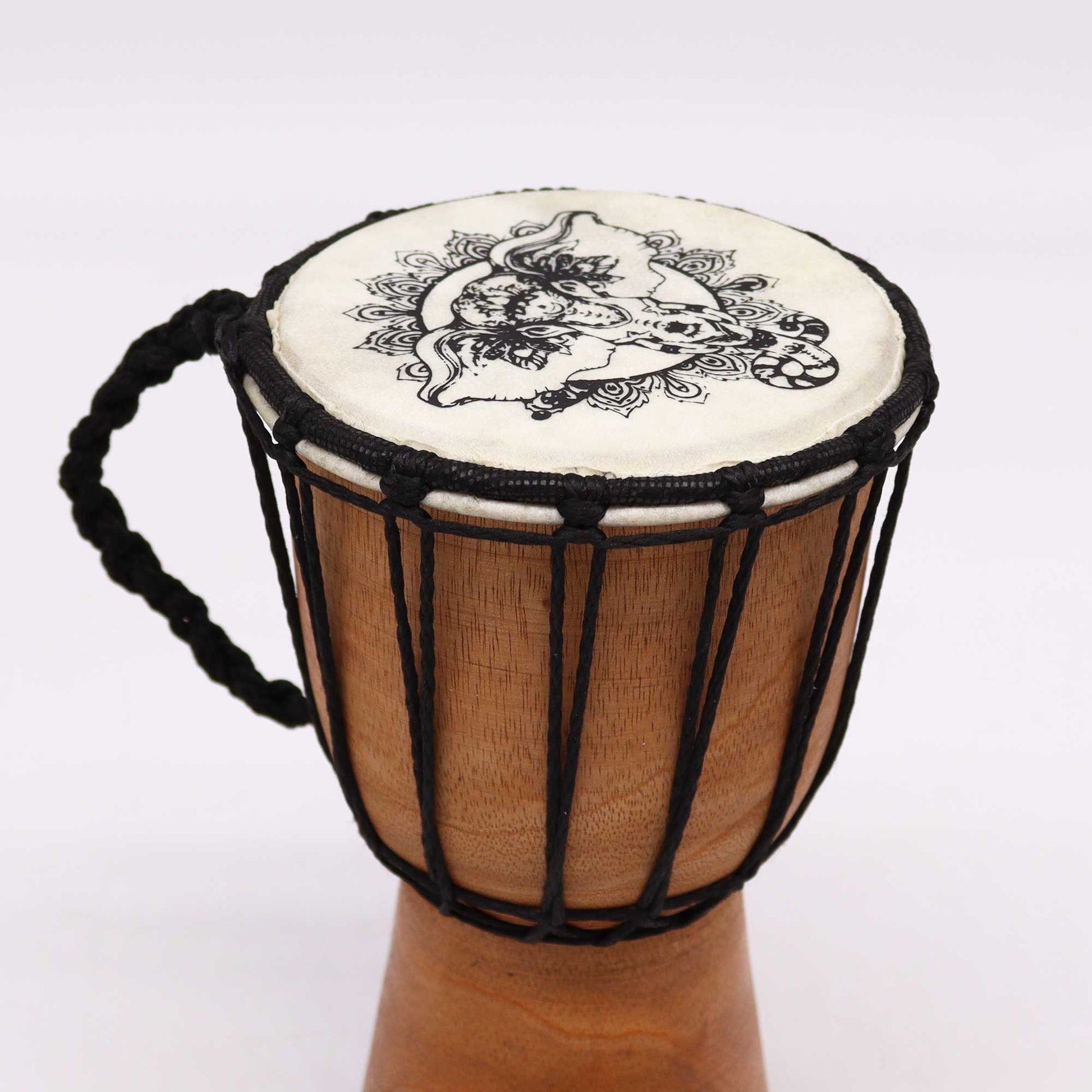 Handmade djembe drum with elephant motif and braided handle.