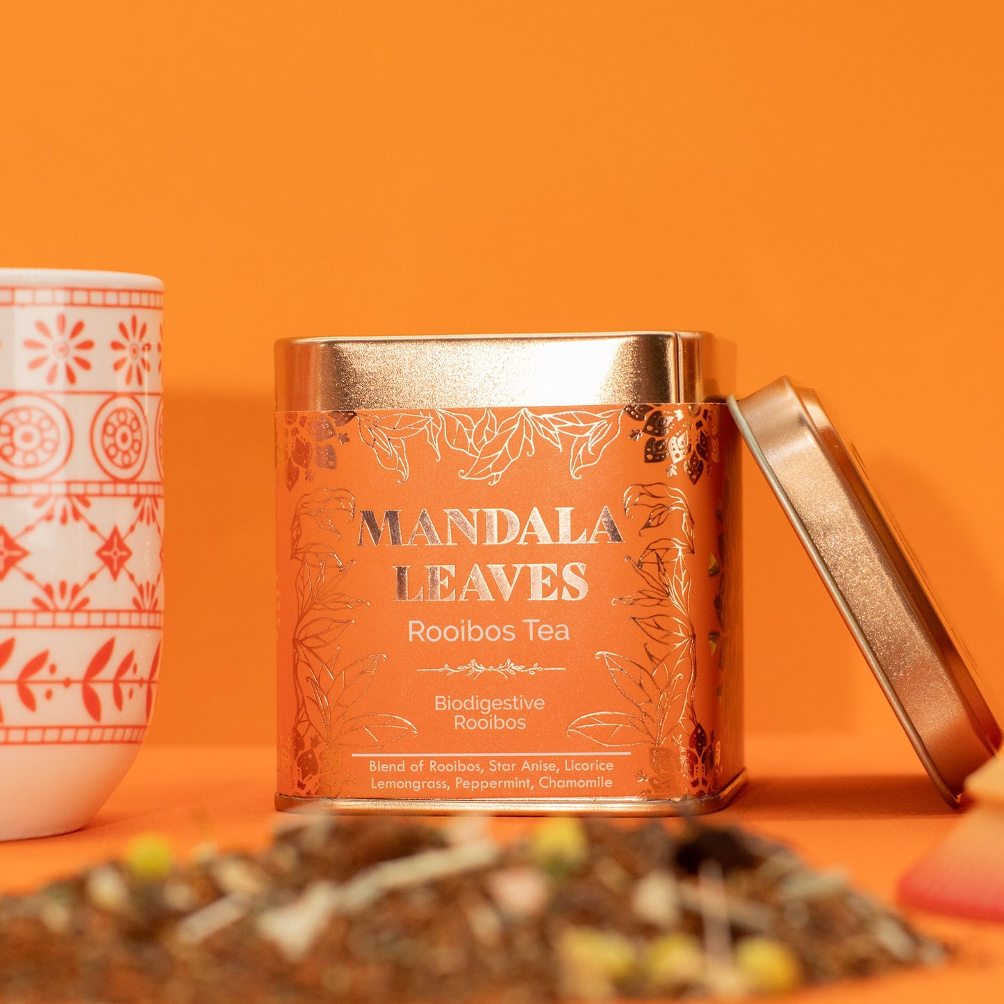 A copper tin of Mandala Leaves Rooibos Tea with a partially open lid.