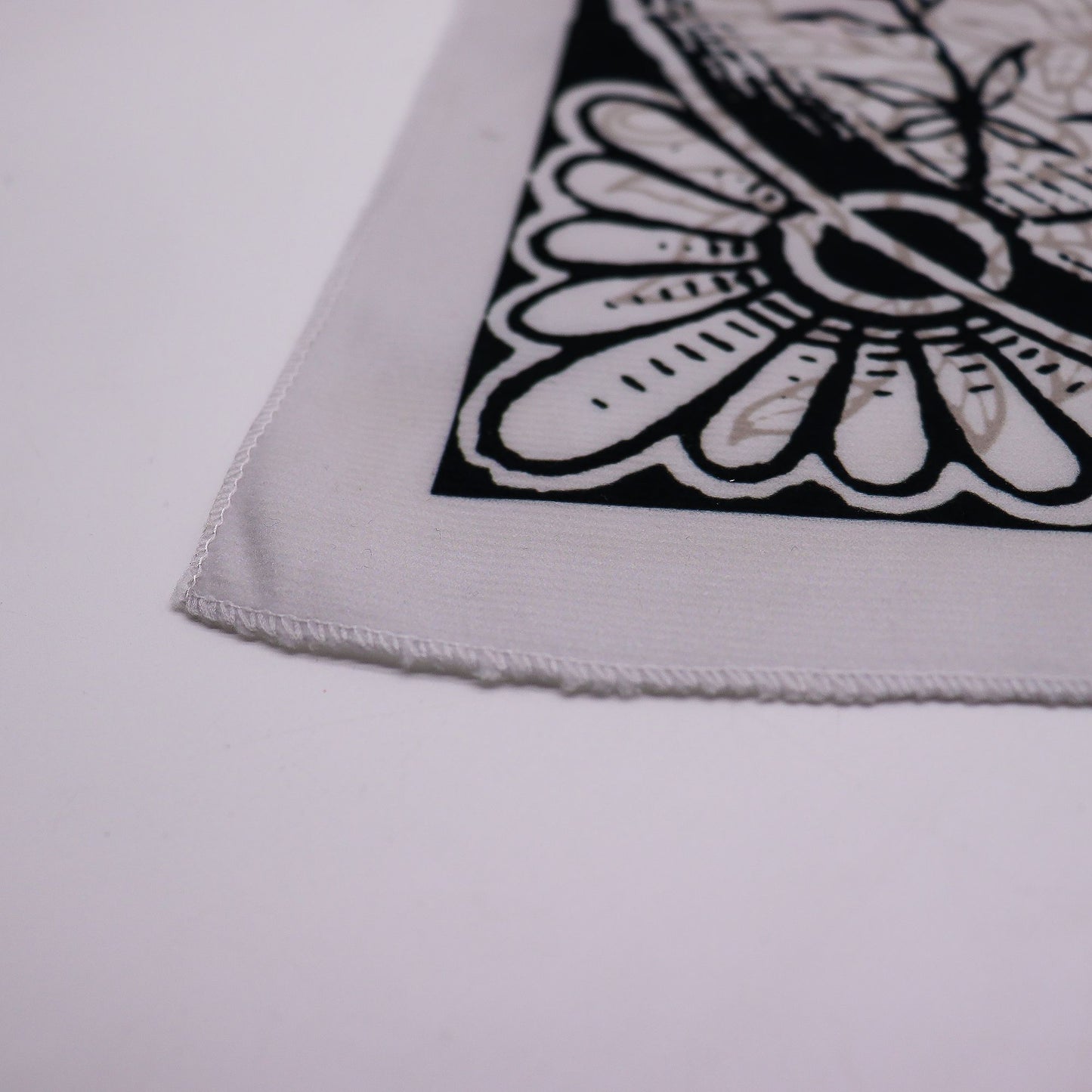 A white tarot cloth with a black and beige Tree of Life design.