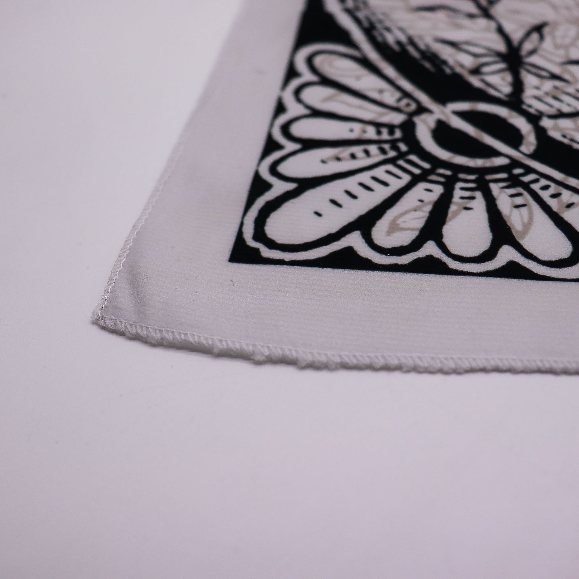A white tarot cloth with a black and beige Tree of Life design.