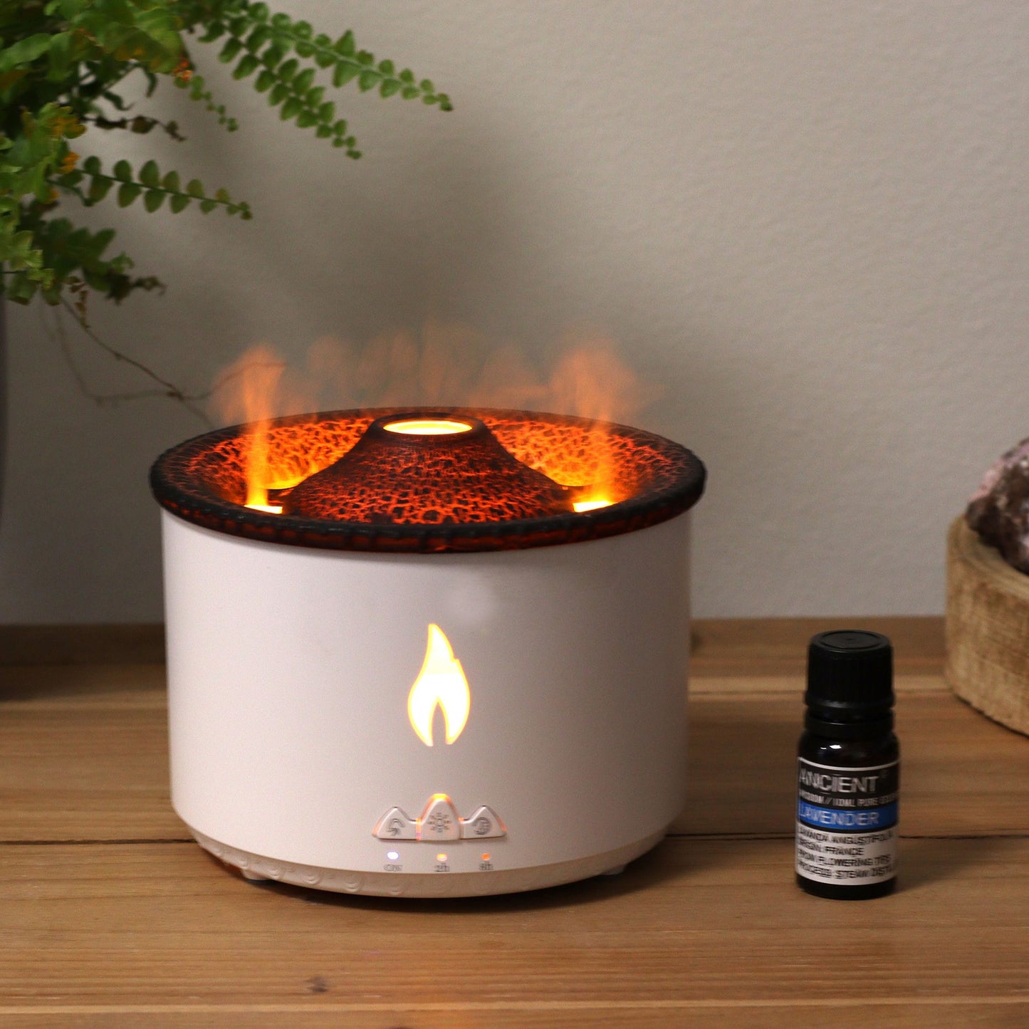 Medium volcano effect aroma diffuser with a flame light and a bottle of lavender essential oil.