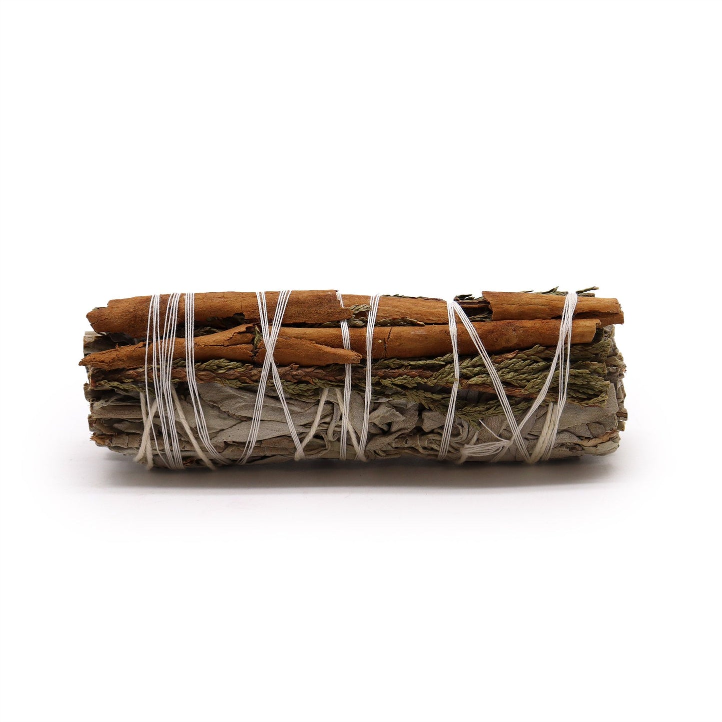 Smudge stick bundle of white sage, cedar, and cinnamon sticks tied with white string.