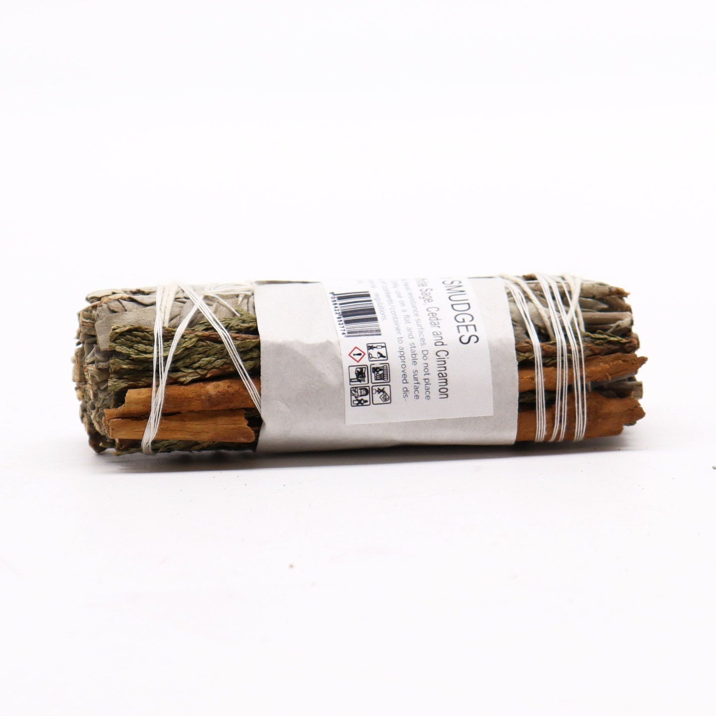 Smudge stick with white sage, cedar, and cinnamon bound with string.