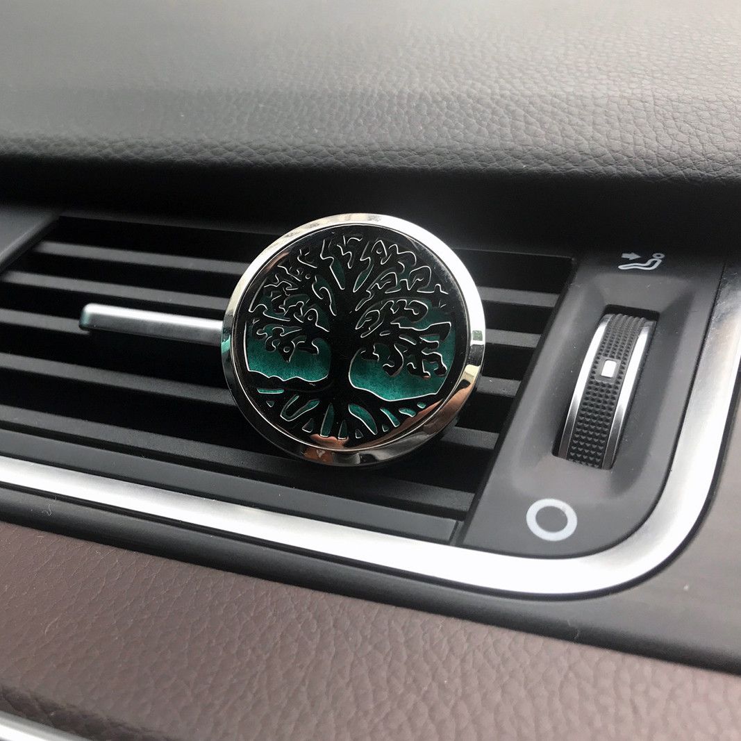 Auto-Aroma-Diffuser mit Lebensblumen-Design und silbernem Rand.