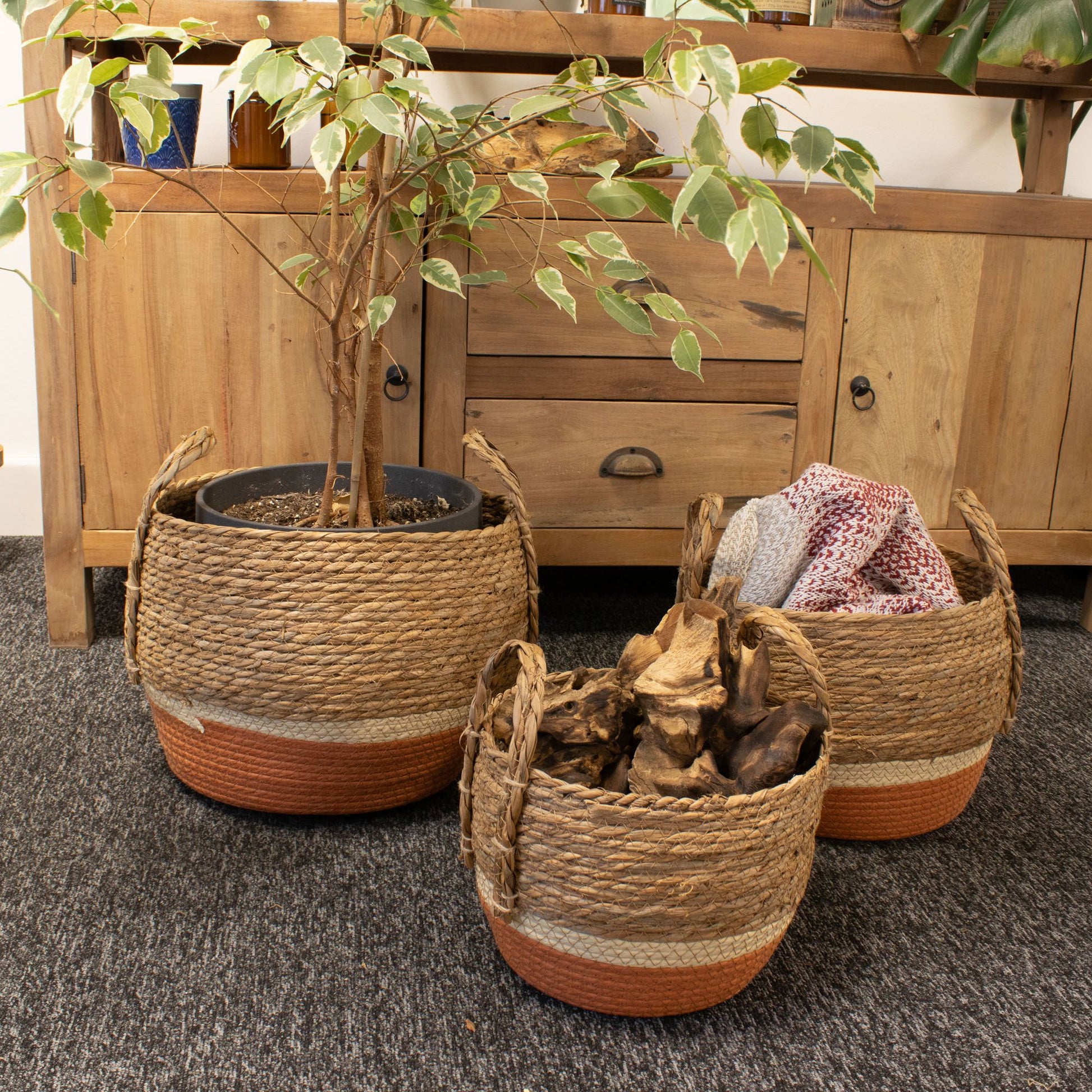 Set of 3 natural and orange straw and seagrass baskets.
