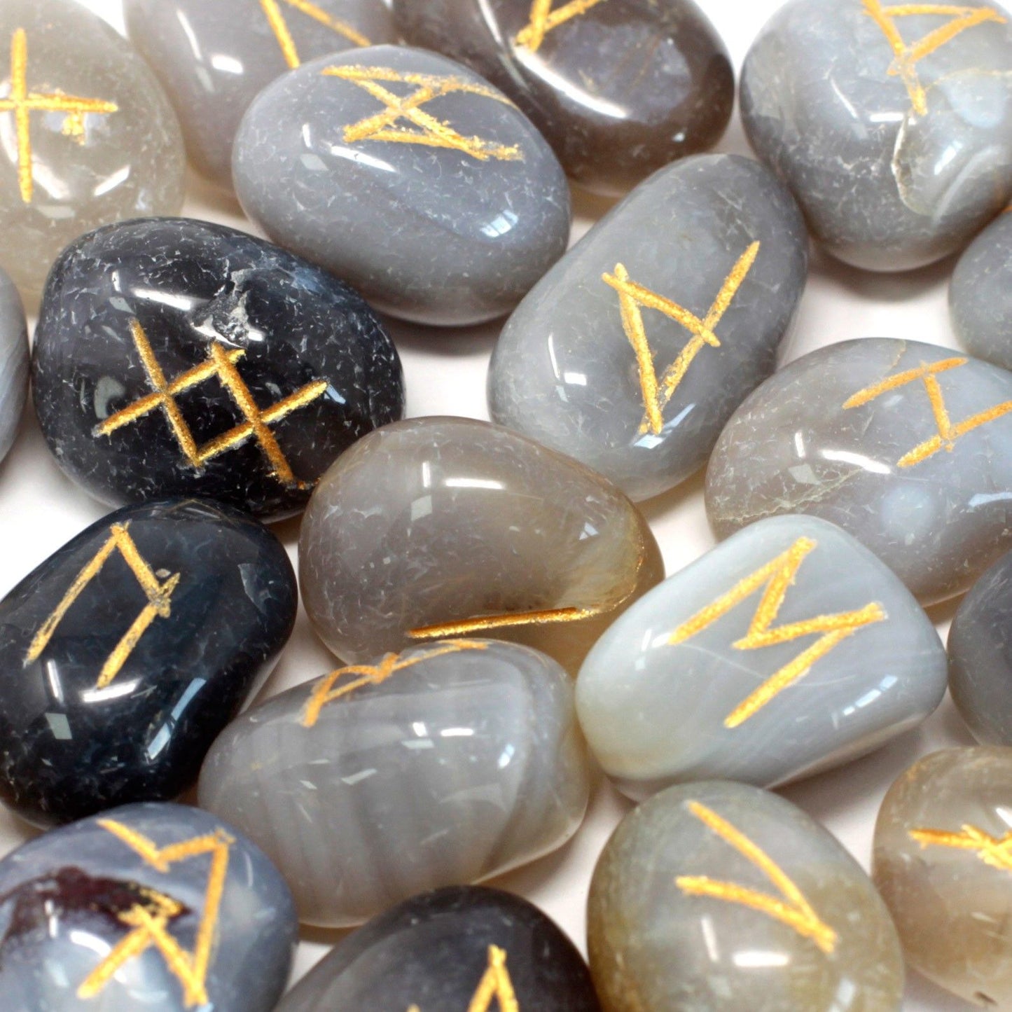 Grey agate rune stones with gold symbols.