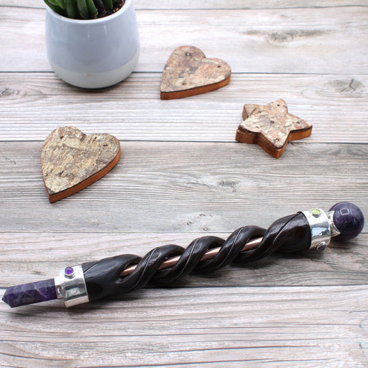 Spiral carving healing wand with copper pipe and amethyst crystals.