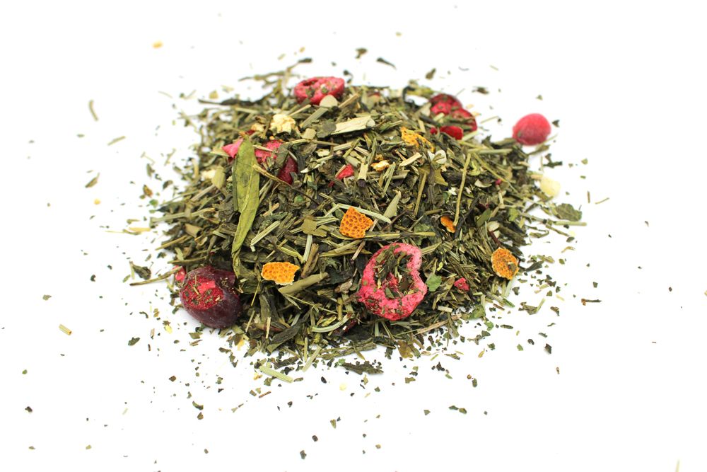 Pile of green tea with dried berries and orange peel.