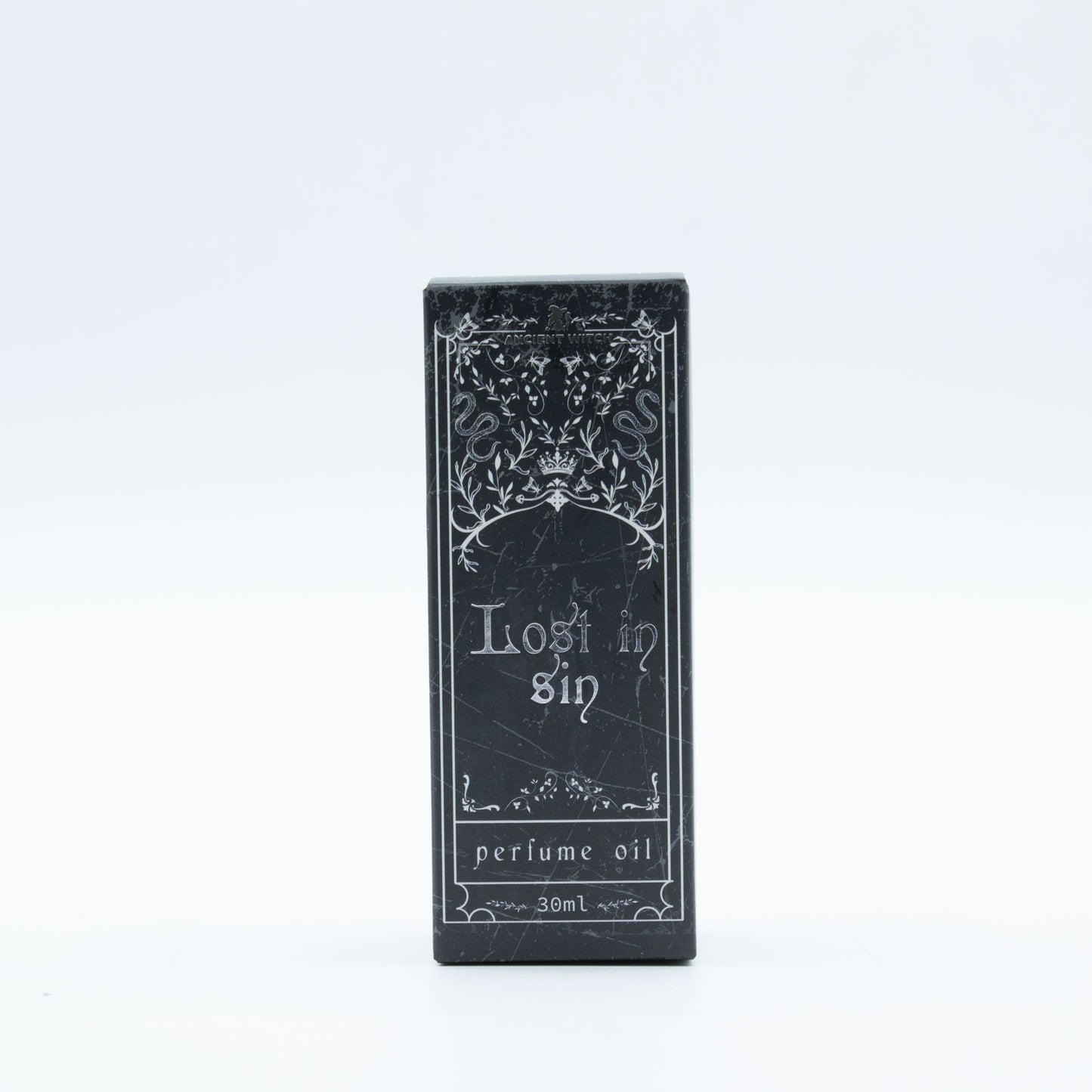 A black box with "Lost in Sin perfume oil 30ml" and ornate designs.