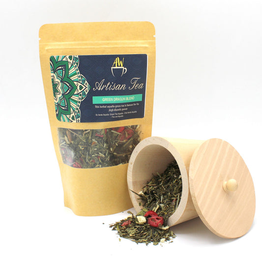 A bag of Green Dragon Blend tea next to a wooden container filled with tea.