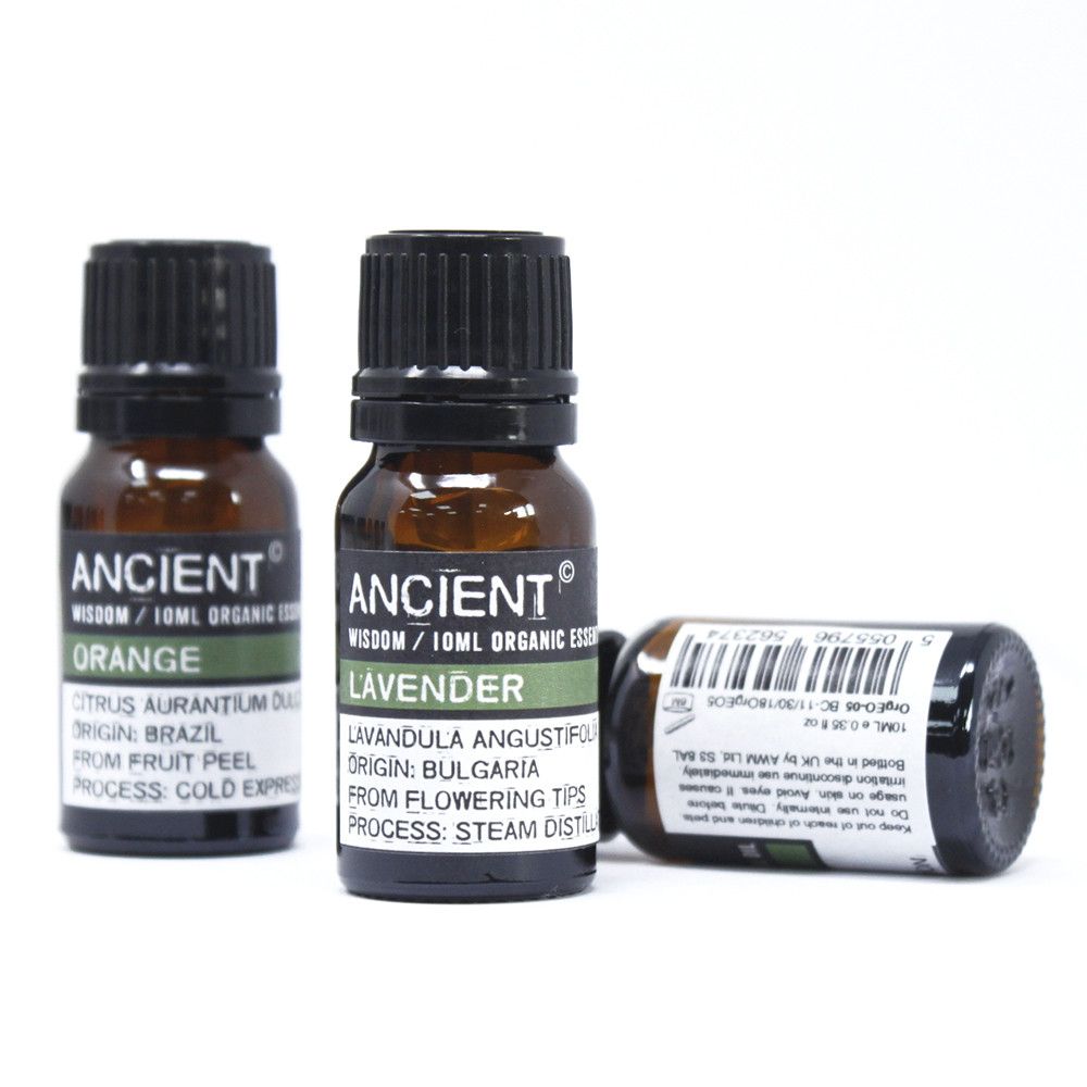 Three bottles of essential oil, two upright and one lying down, with labels.