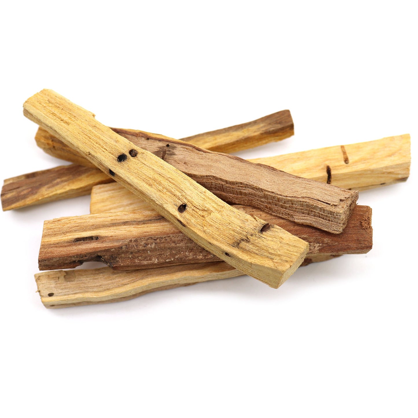 A pile of natural, light brown Palo Santo wood sticks with visible grain and small dark spots.