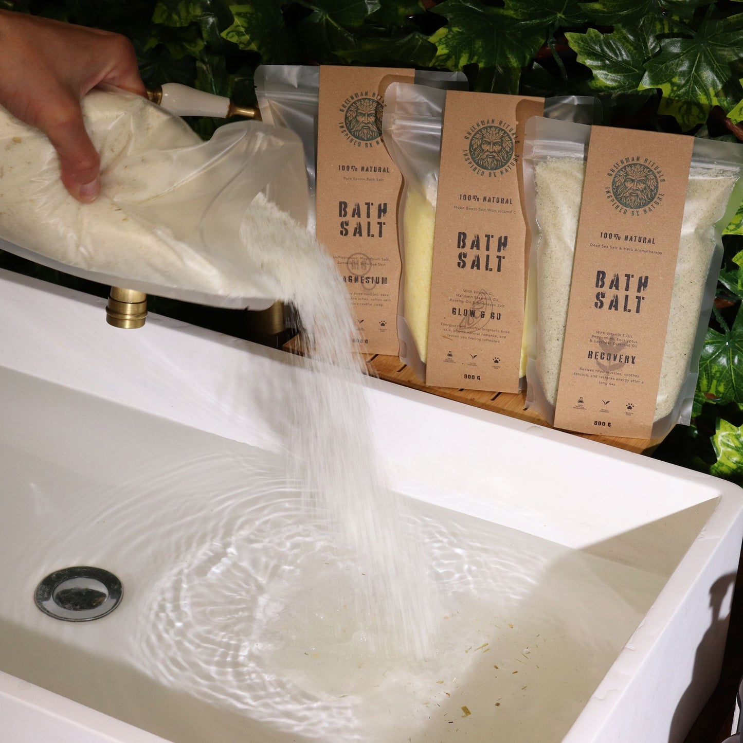 Greenman Rituals Oat & Honey Epsom Bath Salt being poured into a bathtub.