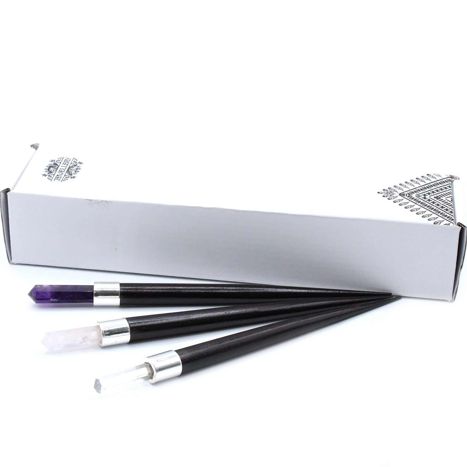 Three pointed healing wands with amethyst, rose quartz, and clear quartz tips.