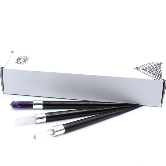 Three pointed healing wands with amethyst, rose quartz, and clear quartz tips.