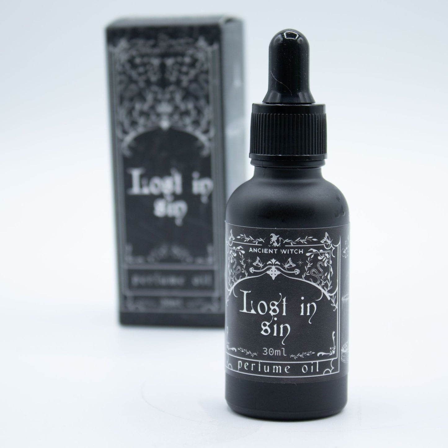 A black bottle of "Lost in Sin" perfume oil by Ancient Witch.