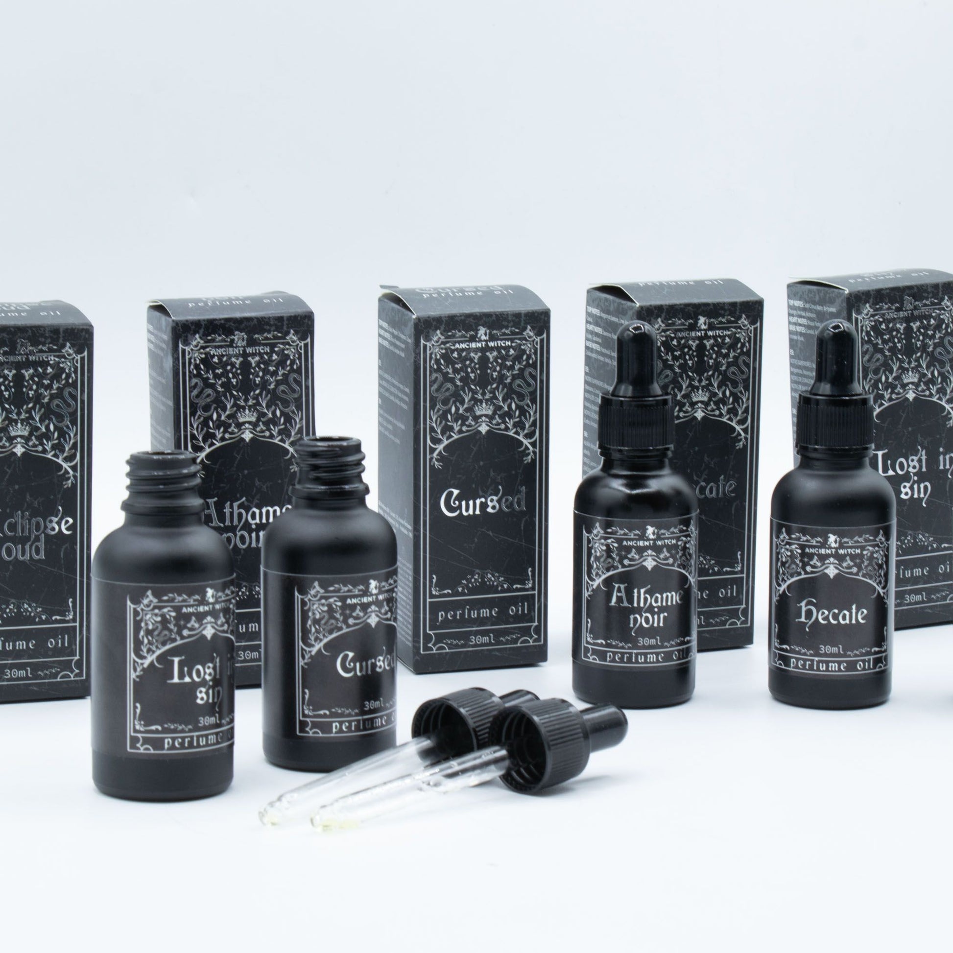 Black bottles of Ancient Witch perfume oil with ornate labels, including "Lost in Sin."