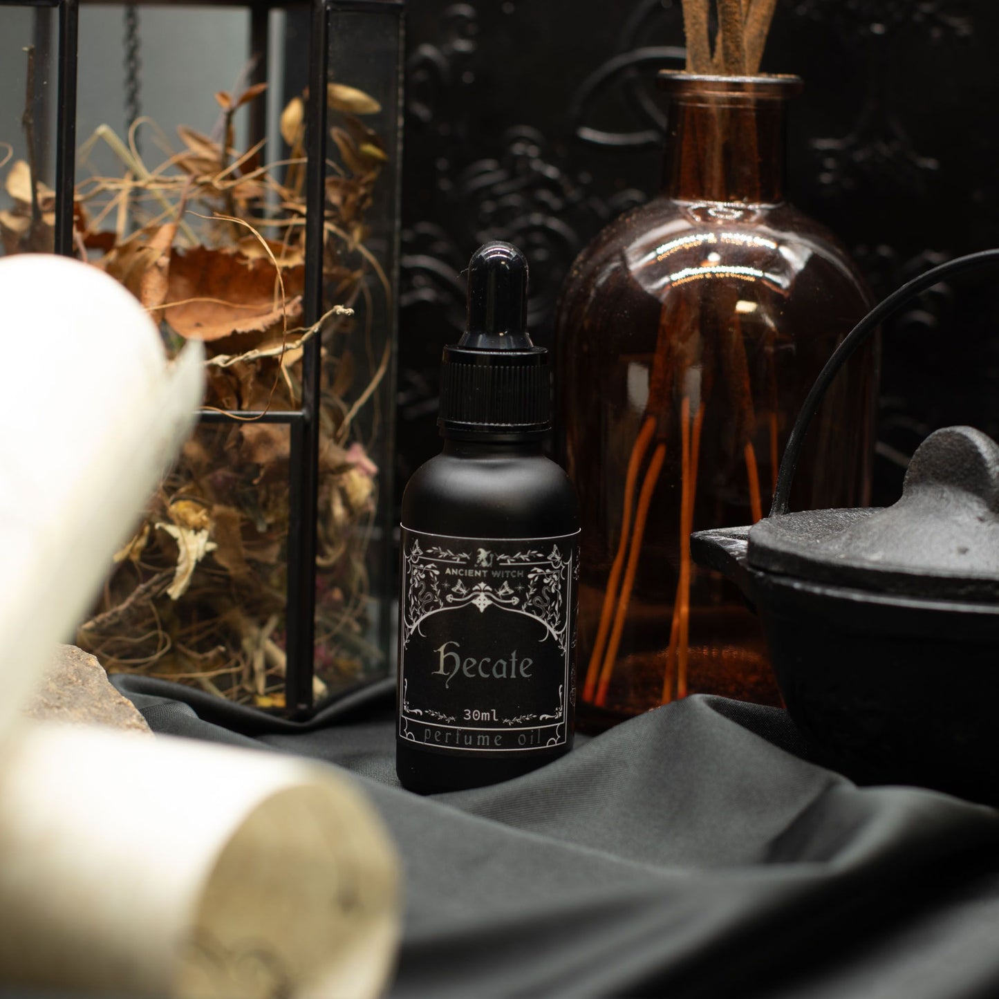 Black bottle of Hecate perfume oil with a dropper lid.