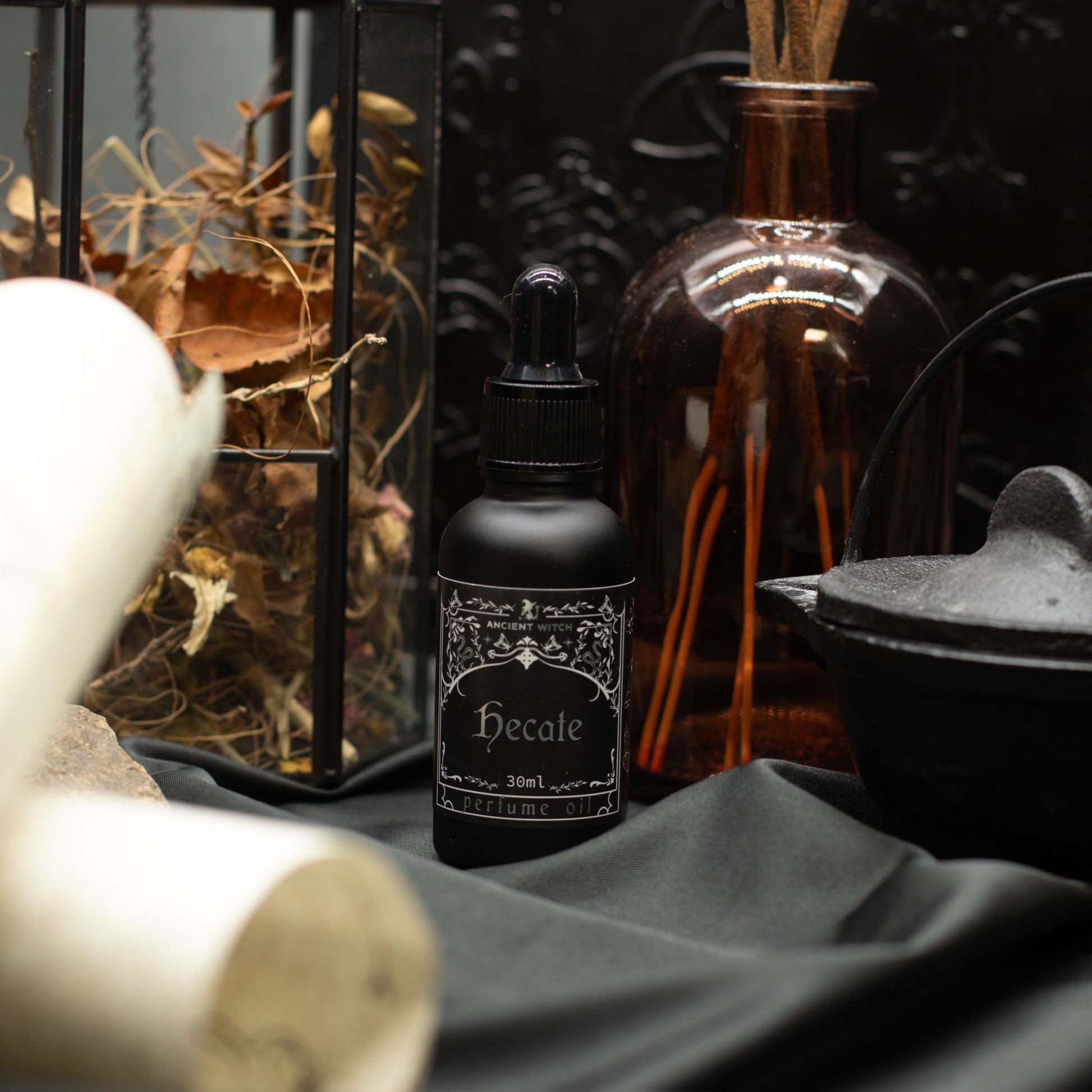 Black bottle of Hecate perfume oil with a dropper lid.