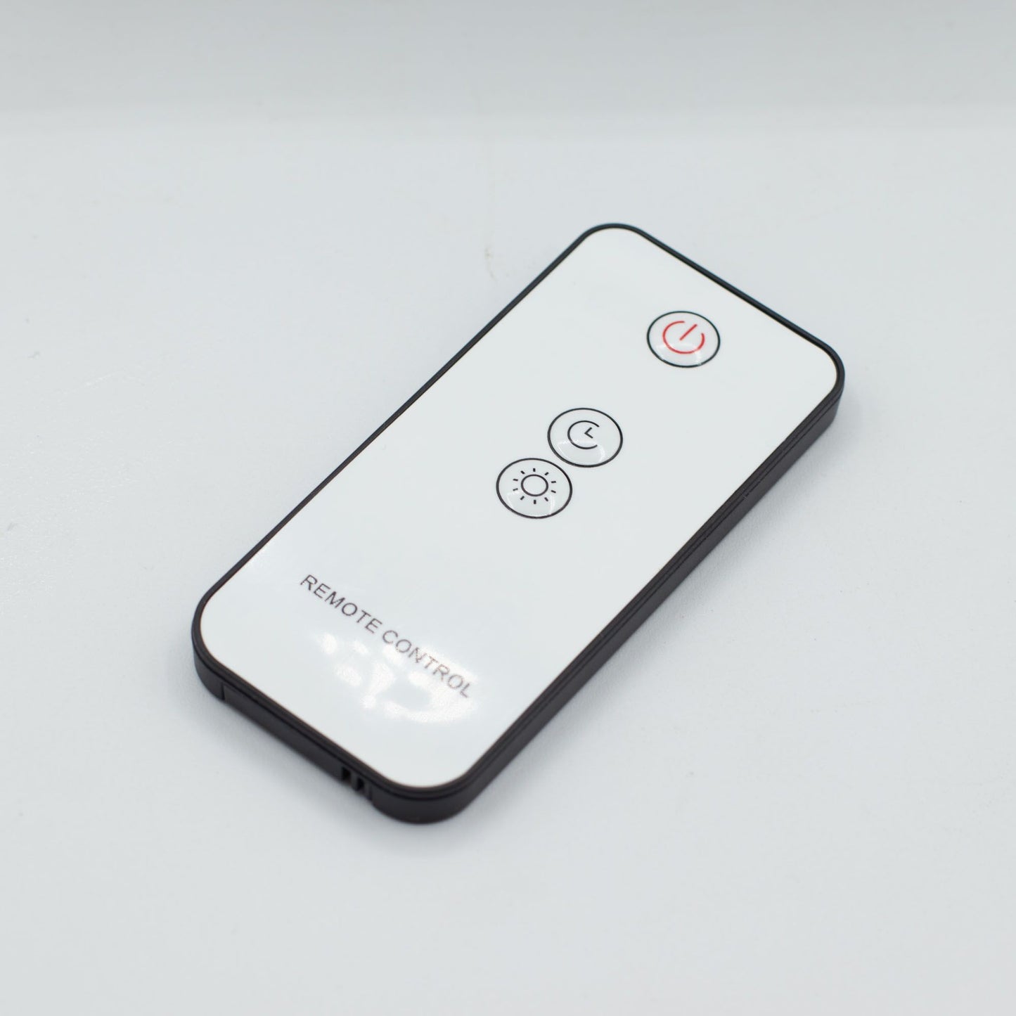 White remote control with power, timer, and light icons.