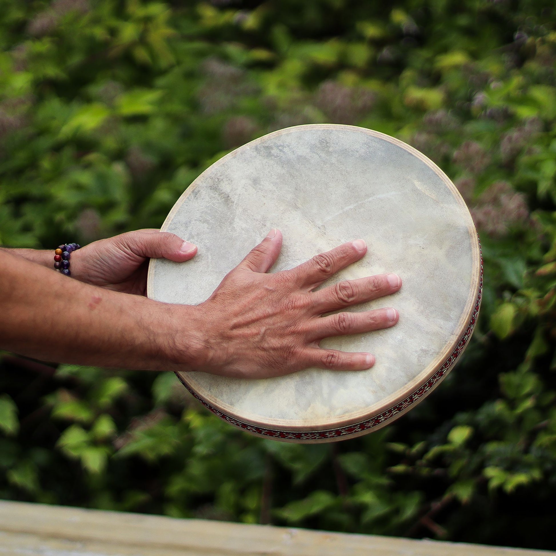 A 30cm shaman ocean drum with a goatskin head and decorative frame.