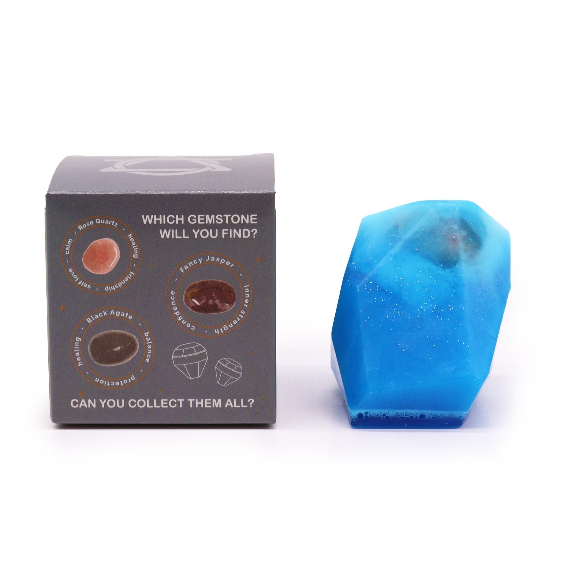 A blue, faceted soap with glitter sits next to a box showing different gemstones.