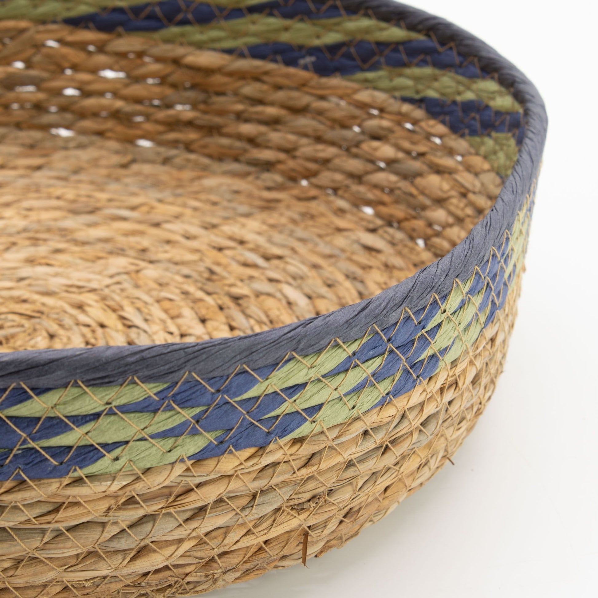 Woven straw and seagrass tray basket with blue and green detailing.