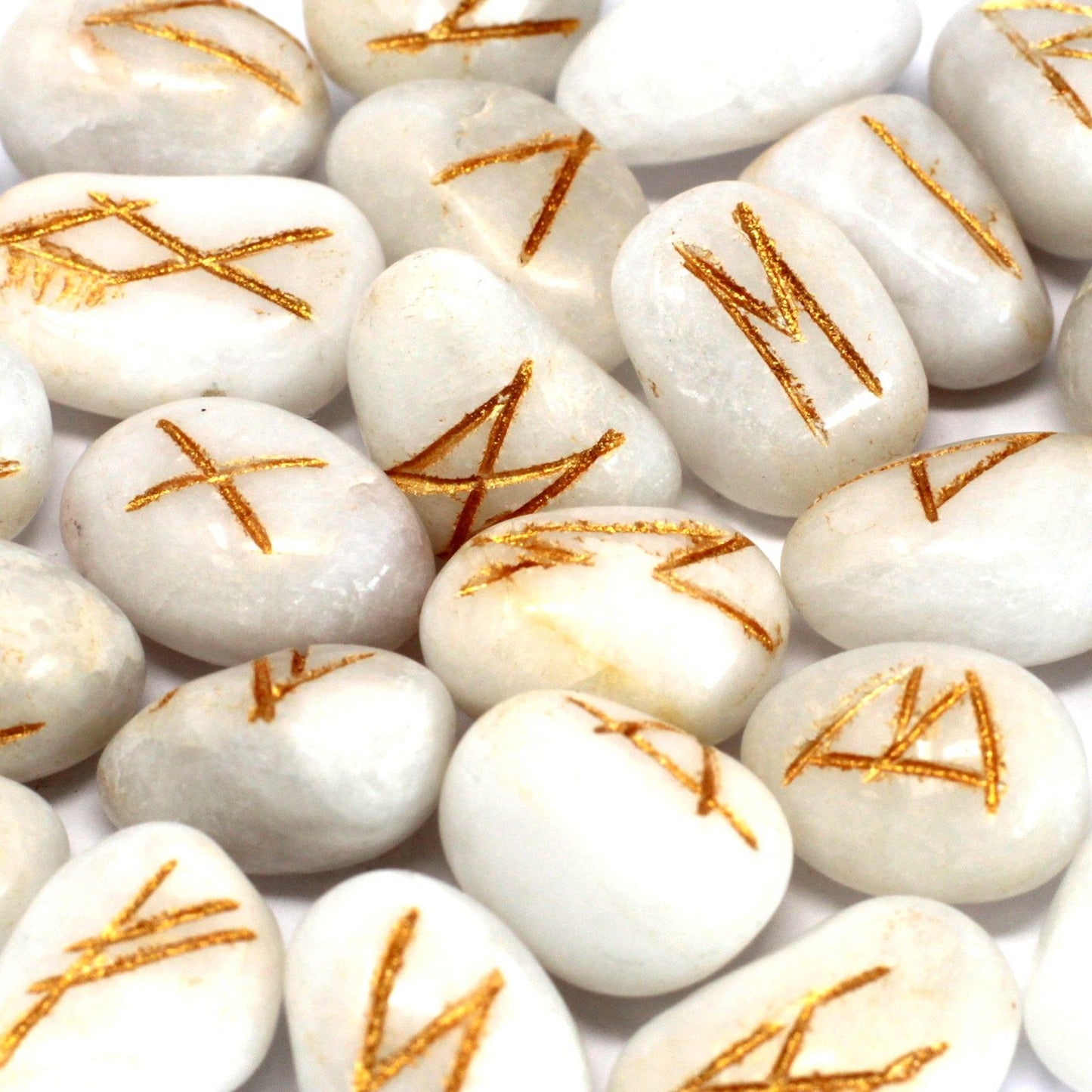 White agate rune stones with gold symbols.