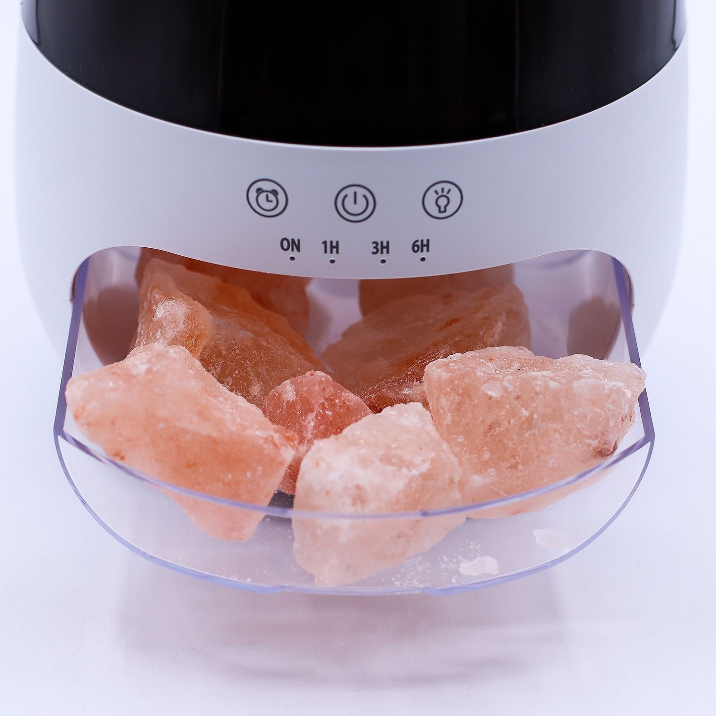 White aroma diffuser with salt stones, flame effect light, and timer options.